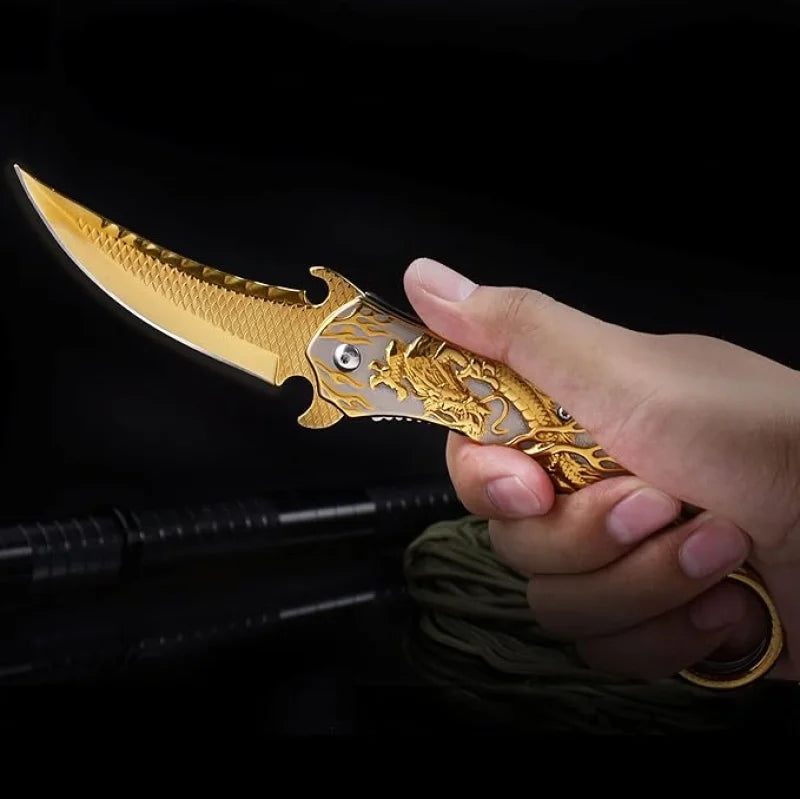 Portable folding knife with gold dragon relief design